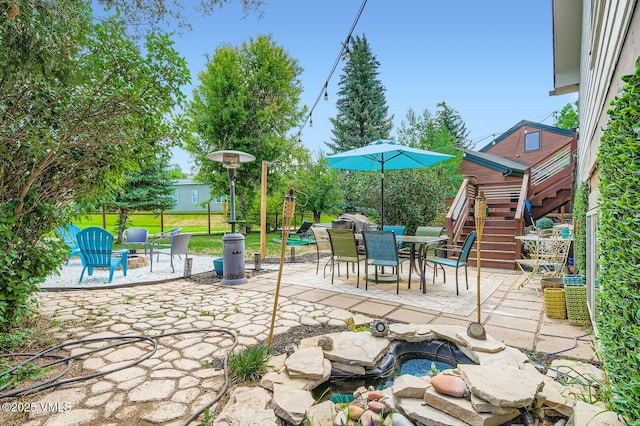 751 Bull Run, Eagle, CO 81631 - view of patio featuring stairs, outdoor dining space, and a jacuzzi