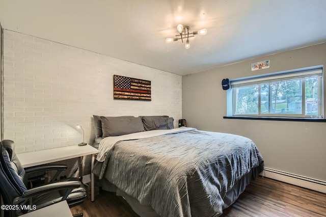 751 Bull Run, Eagle, CO 81631 - bedroom featuring a baseboard heating unit, brick wall, and wood finished floors