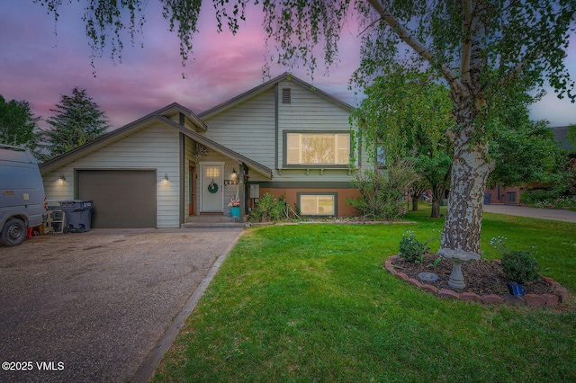 751 Bull Run, Eagle, CO 81631 - split level home with asphalt driveway, a yard, and a garage
