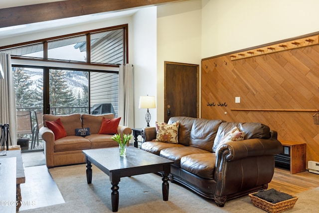 177 Lake St Unit 24, Avon, CO 81620 - living area featuring healthy amount of natural light, wood walls, light wood-type flooring, and a towering ceiling