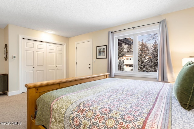 bedroom featuring a closet, light carpet, and a textured ceiling