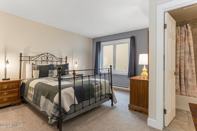 bedroom with light carpet, a baseboard heating unit, and a textured ceiling