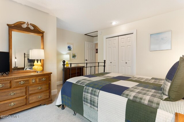 bedroom featuring a closet and light carpet