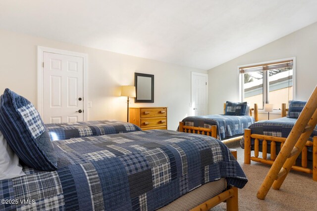 carpeted bedroom with lofted ceiling