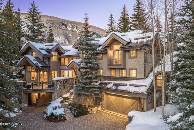 view of front facade featuring a mountain view and a garage