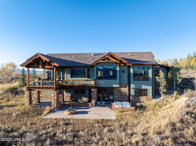 96 Pikes Way, Edwards, CO 81632 - back of property featuring a fire pit, a patio, a deck, and board and batten siding