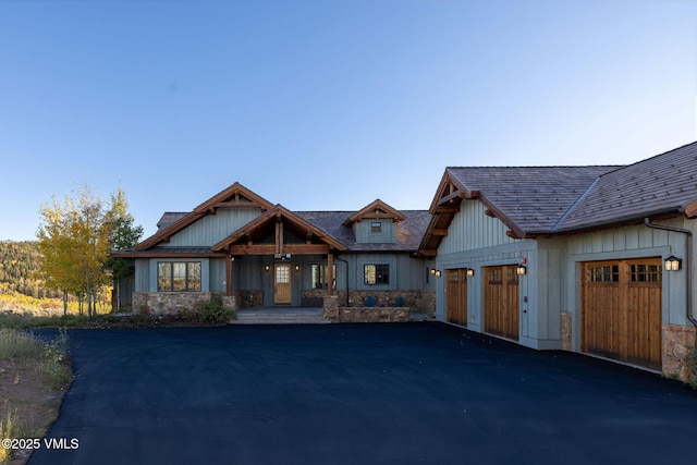 96 Pikes Way, Edwards, CO 81632 - craftsman house featuring driveway, an attached garage, and stone siding