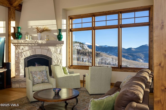 96 Pikes Way, Edwards, CO 81632 - living area featuring a mountain view, wood finished floors, a fireplace with raised hearth, and plenty of natural light