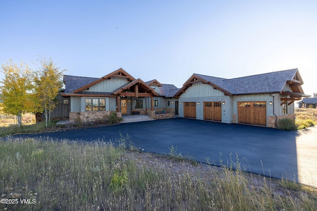 96 Pikes Way, Edwards, CO 81632 - view of front facade featuring driveway, a garage, roof with shingles, and stone siding