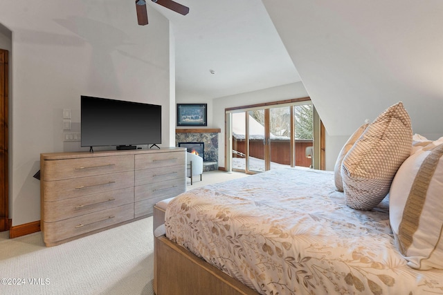 57 Mccoy Creek Dr Unit A, Edwards, CO 81632 - bedroom featuring light colored carpet, a stone fireplace, lofted ceiling, access to outside, and a ceiling fan