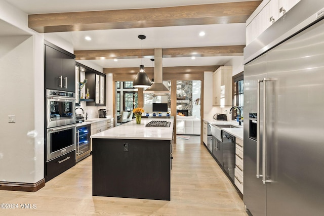 57 Mccoy Creek Dr Unit A, Edwards, CO 81632 - kitchen featuring appliances with stainless steel finishes, a center island, dark cabinetry, light countertops, and recessed lighting