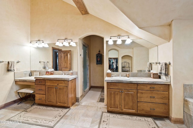 57 Mccoy Creek Dr Unit A, Edwards, CO 81632 - bathroom featuring two vanities, a shower stall, and lofted ceiling