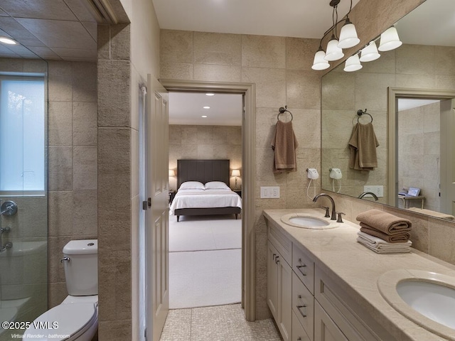 57 Mccoy Creek Dr Unit A, Edwards, CO 81632 - ensuite bathroom with tile walls, double vanity, healthy amount of natural light, and tile patterned floors