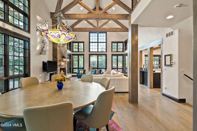 57 Mccoy Creek Dr Unit A, Edwards, CO 81632 - dining room with high vaulted ceiling, beamed ceiling, a stone fireplace, wood finished floors, and recessed lighting