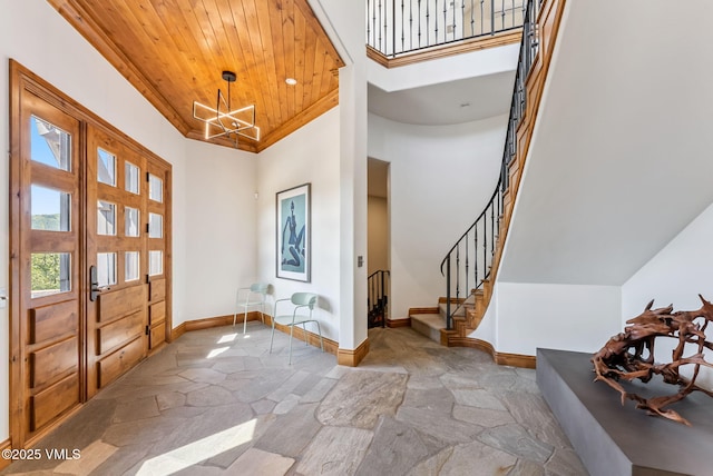 196 Spring Creek Ln, Edwards, CO 81632 - entryway featuring stone flooring, wooden ceiling, stairway, a chandelier, and a high ceiling