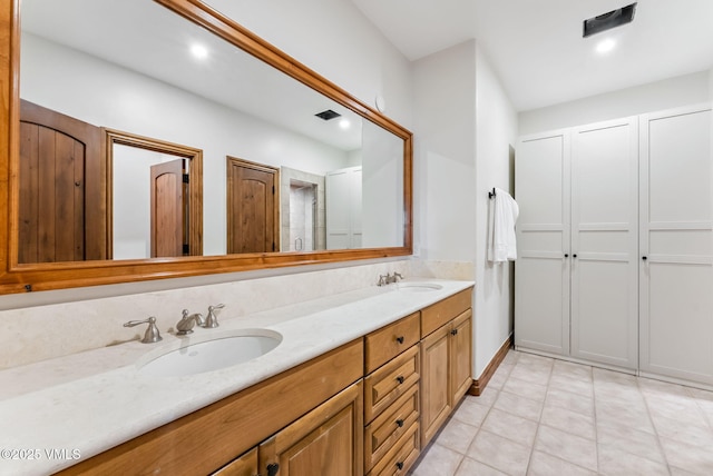 196 Spring Creek Ln, Edwards, CO 81632 - bathroom featuring double vanity, tile patterned floors, and a closet