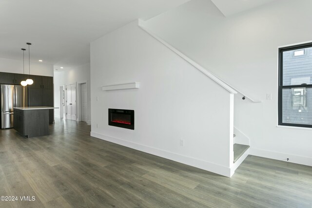 unfurnished living room with dark hardwood / wood-style floors