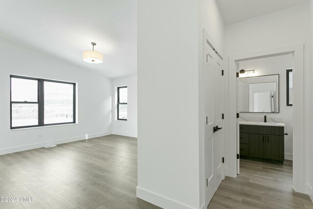 hall featuring sink and light hardwood / wood-style floors