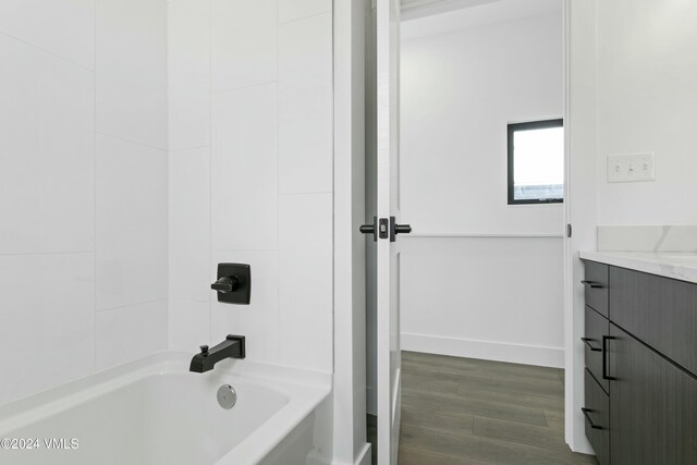 bathroom featuring vanity, hardwood / wood-style floors, and shower / bathtub combination