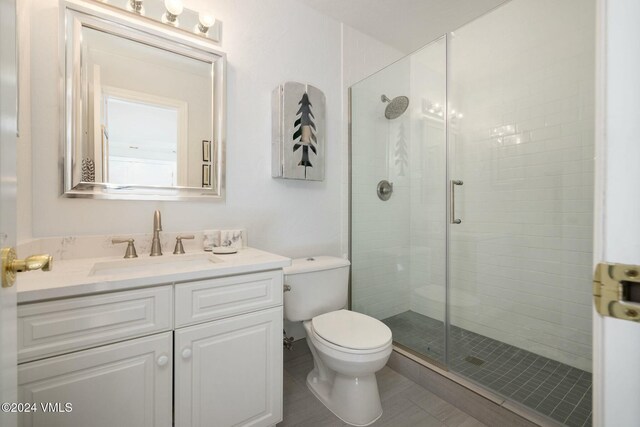 bathroom with vanity, toilet, and an enclosed shower