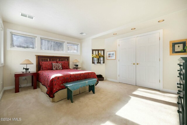 carpeted bedroom with a closet