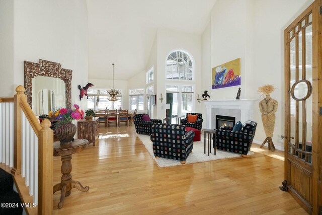 living room featuring hardwood / wood-style floors, high vaulted ceiling, and french doors