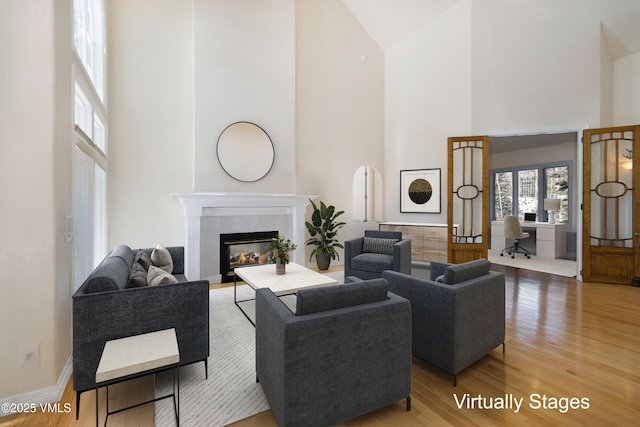 4465 Glen Falls Ln, Vail, CO 81657 - living area featuring high vaulted ceiling, wood finished floors, and a fireplace