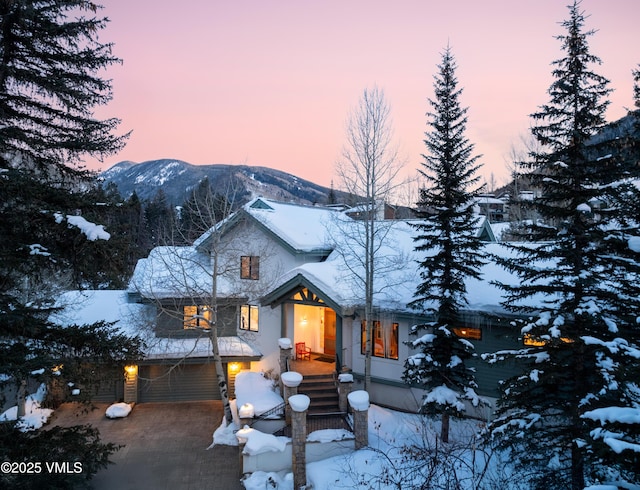 view of front of house featuring a garage and a mountain view