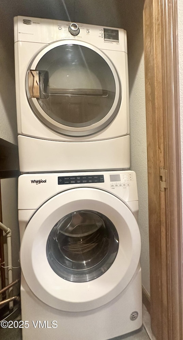 240 Chapel Pl Unit Br-309, Avon, CO 81620 - washroom with stacked washer / drying machine and a textured wall