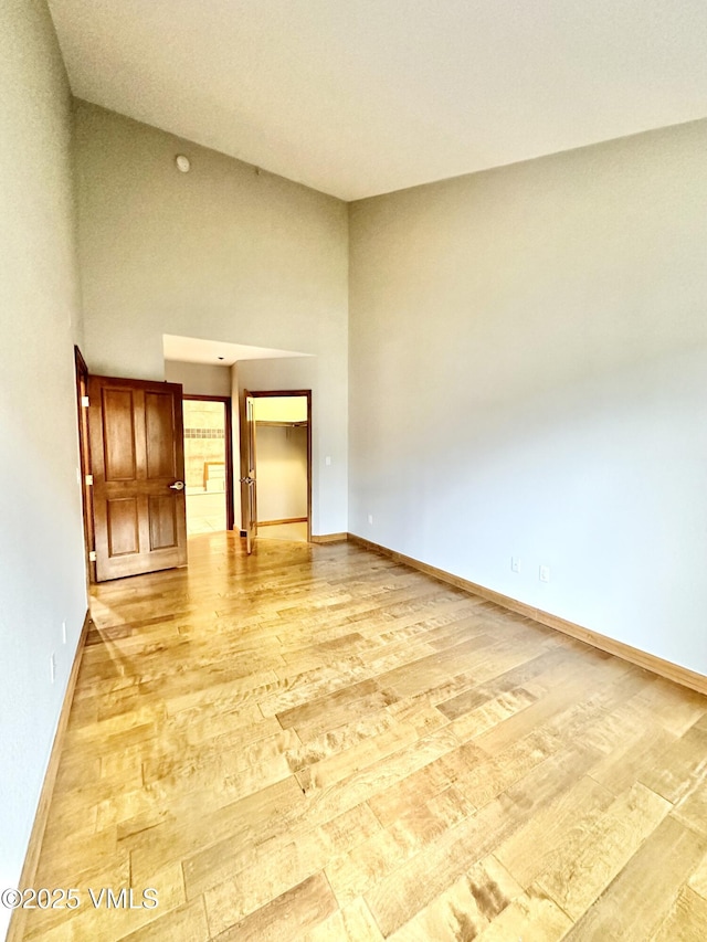 240 Chapel Pl Unit Br-309, Avon, CO 81620 - empty room with light wood finished floors and a towering ceiling