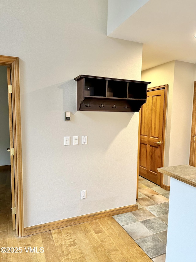 240 Chapel Pl Unit Br-309, Avon, CO 81620 - mudroom featuring baseboards and light wood-style flooring