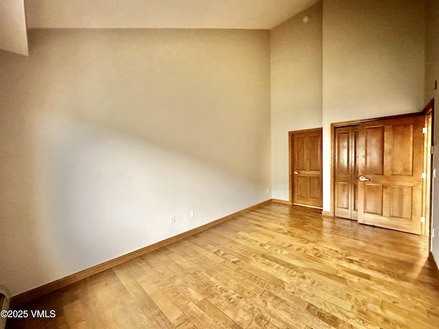 240 Chapel Pl Unit Br-309, Avon, CO 81620 - unfurnished bedroom featuring wood finished floors and a high ceiling