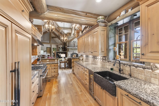 1416 Red Draw, Edwards, CO 81632 - kitchen featuring double oven range, light brown cabinets, backsplash, a stone fireplace, and recessed lighting