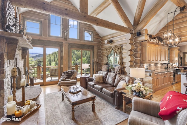 1416 Red Draw, Edwards, CO 81632 - living room with rustic walls, high vaulted ceiling, a chandelier, light wood-type flooring, and beam ceiling