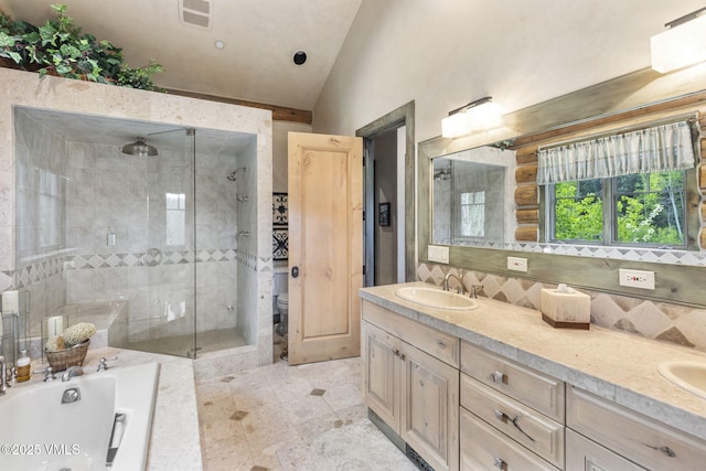 1416 Red Draw, Edwards, CO 81632 - bathroom featuring vaulted ceiling, a shower stall, double vanity, a garden tub, and tasteful backsplash