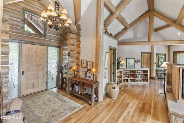 1416 Red Draw, Edwards, CO 81632 - foyer with rustic walls, high vaulted ceiling, a chandelier, beamed ceiling, and wood finished floors
