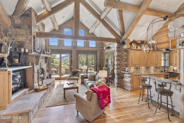 1416 Red Draw, Edwards, CO 81632 - living room with high vaulted ceiling, rustic walls, light wood-style floors, plenty of natural light, and beam ceiling