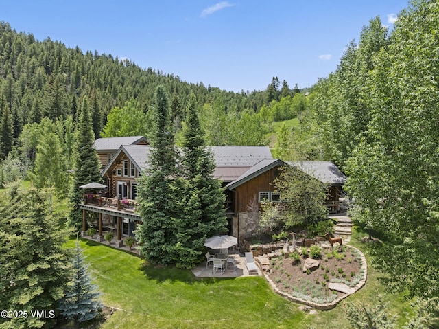 1416 Red Draw, Edwards, CO 81632 - rear view of house with a forest view, a patio area, a lawn, and a wooden deck