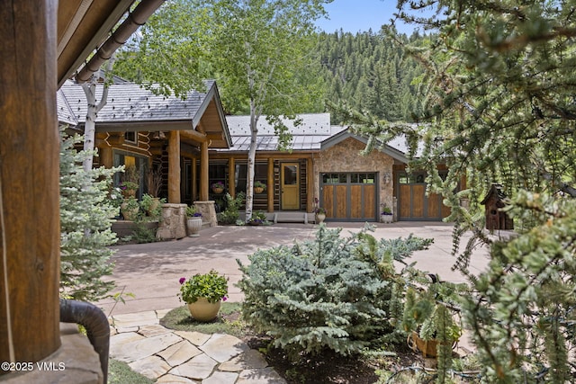 1416 Red Draw, Edwards, CO 81632 - rear view of property featuring a wooded view and stone siding