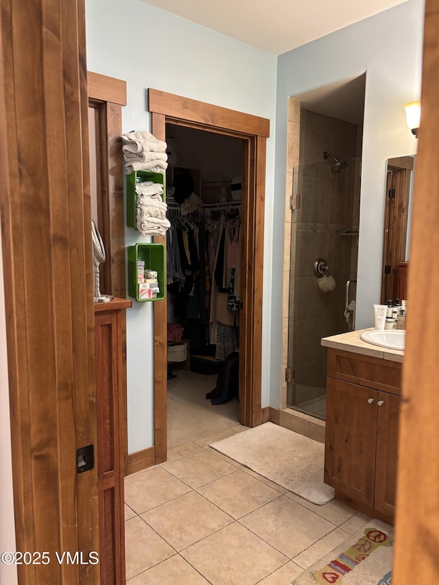 40 Bunker Way, Eagle, CO 81631 - full bathroom featuring a stall shower, vanity, tile patterned flooring, and a spacious closet