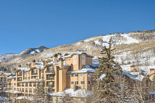 snow covered property with a mountain view