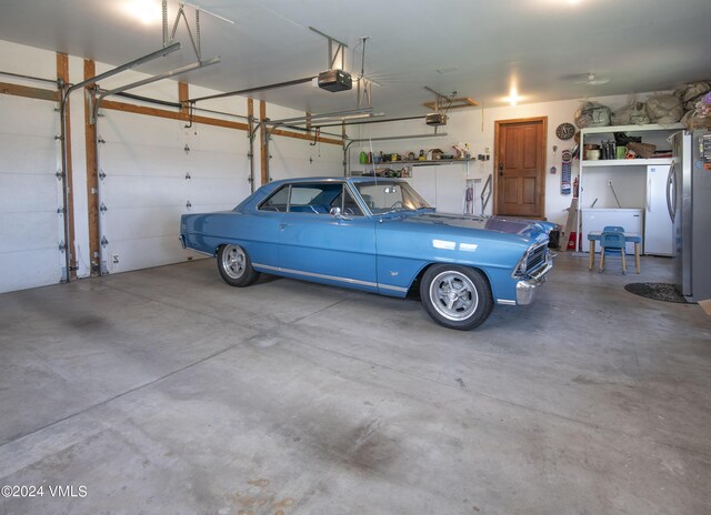 garage with fridge and a garage door opener