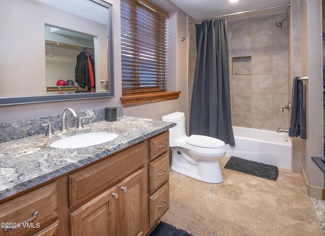 full bathroom featuring vanity, shower / bath combination with curtain, and toilet