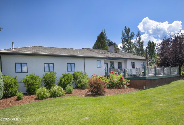 rear view of property with a lawn