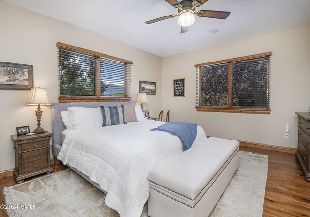 bedroom with hardwood / wood-style flooring and ceiling fan