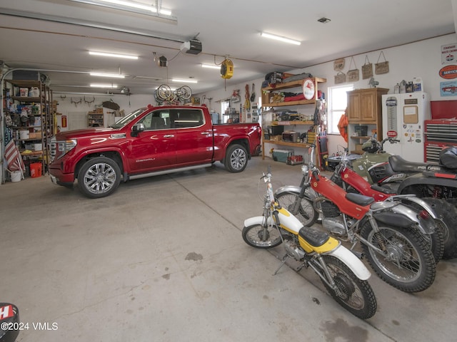 garage featuring a garage door opener and refrigerator