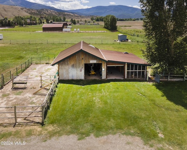 exterior space featuring central AC, a mountain view, a rural view, and an outdoor structure