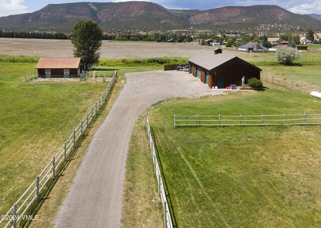 birds eye view of property featuring a mountain view and a rural view