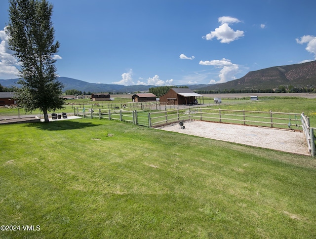 view of yard featuring a mountain view and a rural view