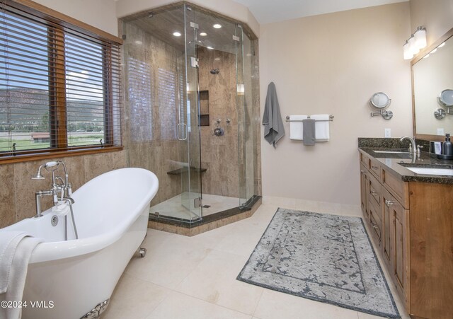 bathroom featuring vanity, tile patterned floors, and plus walk in shower